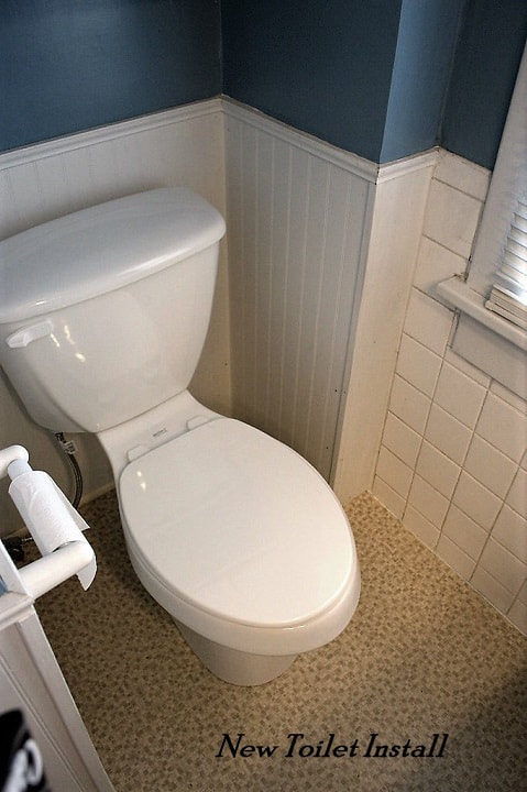 New white elongated toilet install in bathroom